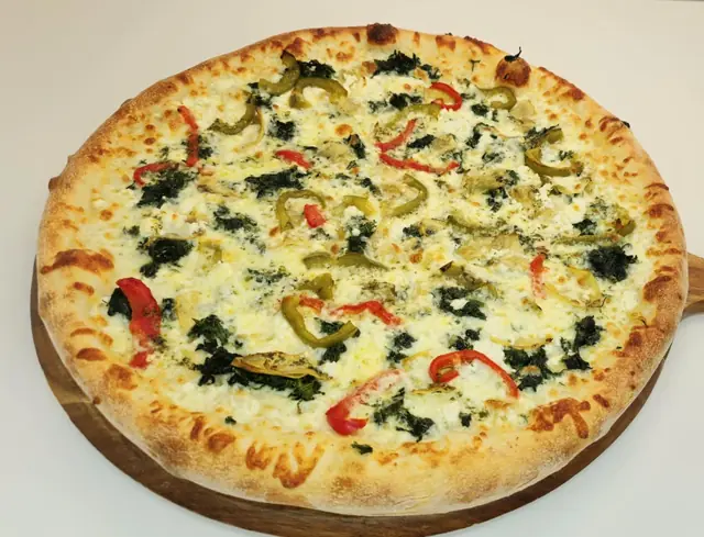 Mediterranean white pizza with spinach and peppers