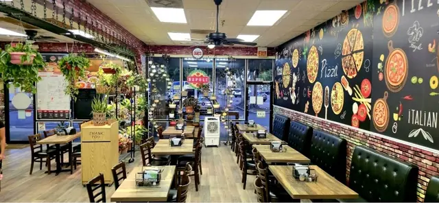 Booths and the colorful pizza mural in the Napoli dining room